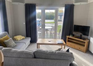 a living room with a couch and a television at Walkers Retreat in Routh