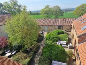 an overhead view of a garden with chairs and trees at Osprey Meadow Holiday Cottages in Bedale