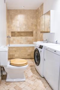 a bathroom with a toilet and a washing machine at Spacious Family Friendly apartment, Free Parking in Tallinn