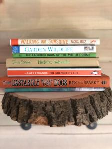 a stack of books sitting on top of a table at Old Oak Farm in Oakham