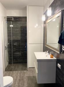 a bathroom with a toilet and a sink and a shower at Project Comfort Apartament Jana Kazimierza 17/47 Wola in Warsaw