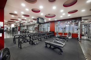 a gym with a row of benches and machines at Bliss Residence & Spa in Budapest