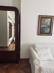 een spiegel naast een bank in een kamer bij Villa Cipriano in Minturno