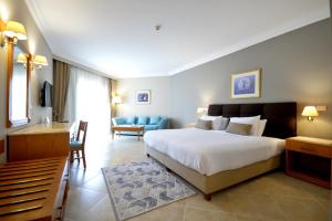 A bed or beds in a room at Aurora Oriental Resort Sharm El Sheikh