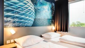 Postel nebo postele na pokoji v ubytování B&B Hotel München-Garching + 37 fotografií