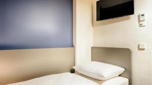 Postel nebo postele na pokoji v ubytování B&B Hotel München-Garching