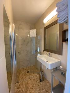 a bathroom with a sink and a shower at Hôtel Le Lichen De La Mer in Batz-sur-Mer
