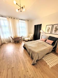 a bedroom with a bed and a table and chairs at Cozy apartment close to Palmovka in Prague