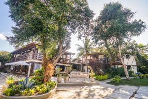 a building with trees in front of it at Pousada Blue Marlin in Búzios