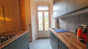 a kitchen with a wooden counter top and a window at Casa Claudia Pieve centro storico in Tremosine Sul Garda