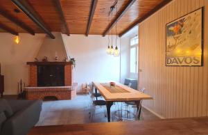 a dining room with a table and a fireplace at Casa Claudia Pieve centro storico in Tremosine Sul Garda
