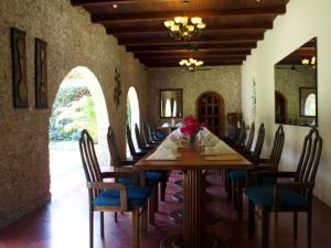 un comedor con una mesa larga y sillas en Hotel del Patio, en Flores