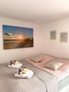 a bedroom with two beds with towels on them at Apartment Glesch in Bergheim