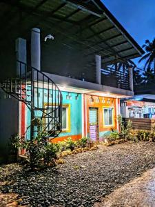 a colorful house with a fire escape on the side of it at Klub Safari Inn & Lounge in Tagbina