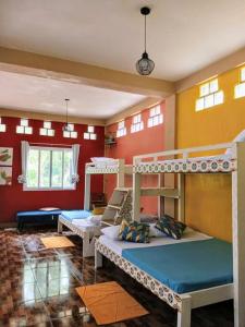 a room with three bunk beds in a room at Klub Safari Inn & Lounge in Tagbina