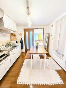 a kitchen with white cabinets and a wooden table at 歌舞伎町704 in Tokyo +23 photos