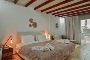 a bedroom with a large bed with towels on it at Tango Studios in Paleokastritsa