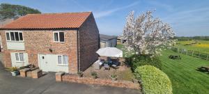 an aerial view of a brick house with a garden at Osprey Meadow Holiday Cottages in Bedale