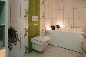 ein Badezimmer mit einem WC, einer Badewanne und einem Waschbecken in der Unterkunft Heaven Spa Apartment in Kranj