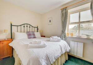 a bedroom with a large bed with towels on it at The Shippon in Askrigg in Askrigg