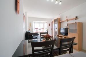 a kitchen and dining room with a table and chairs at TORREMAR 17-E Levante Beach in Benidorm