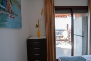 a bedroom with a dresser with a vase on it at TORREMAR 17-E Levante Beach in Benidorm