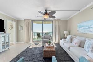 a living room with a white couch and a ceiling fan at Perdido Towers East 403 in Perdido Key