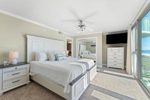 a white bedroom with a bed and a television at Perdido Towers East 403 in Perdido Key +25 photos