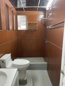 a small bathroom with a toilet and a shower at Experience Colombo like a local in Colombo