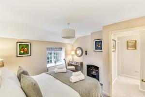 a bedroom with a bed and a fireplace at Brand Hill Cottage with Hot Tub in Loughborough