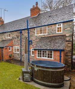 a house with a hot tub in front of it at Brand Hill Cottage with Hot Tub in Loughborough