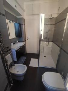 a bathroom with a sink and a toilet and a shower at Casa Mancini in Rome