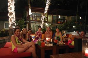 a group of women sitting around a table in a restaurant at Palita Lodge - SHA Plus in Haad Rin