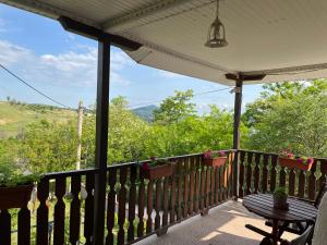 a porch with a table and a view of the mountains at Villa Vesna in Veles
