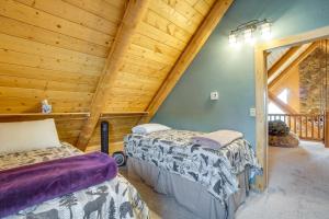 a log cabin bedroom with two beds and a balcony at Mountain-View Front Range Colorado Vacation Rental in Red Feather Lakes