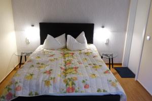 a bedroom with a large bed with two tables at Brocki's Hotel Stadt Hamburg in Parchim +27 photos