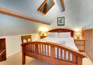 a bedroom with a large wooden bed with a wooden frame at The Old Chapel in Gillamoor