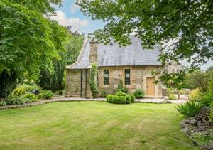 an old stone house with a large yard at The Old Chapel 