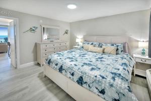 une chambre avec un grand lit avec une couette bleue dans l'établissement Harbour Beach Resort, à Daytona Beach 33 autres photos