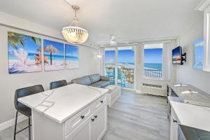 a living room with a couch and a table and chairs at Harbour Beach Resort in Daytona Beach