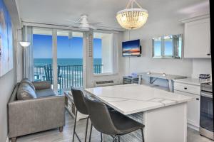 a kitchen and living room with a view of the ocean at Harbour Beach Resort in Daytona Beach
