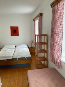 a bedroom with two beds and a ladder at Steiner Stammhaus in Vorderstoder