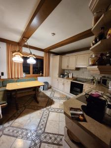 a kitchen with a table in the middle of a room at Merryshof in Sankt Ulrich am Pillersee