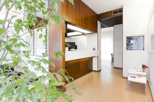 a living room with wood paneling and a hallway at Hotel Molise 2 in Milan