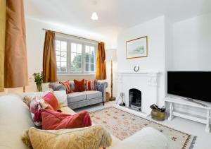 a living room with a couch and a fireplace at Valpre in Manaccan