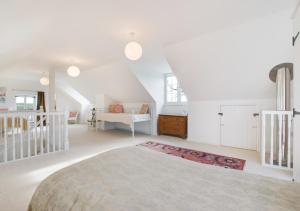 a white bedroom with a large bed in a room at Valpre in Manaccan