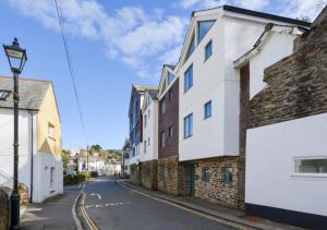 an empty street in a town with buildings at Zephyr in Fowey