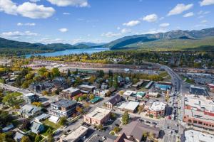 an aerial view of a city with a river and mountains at The Pink Fridge in Whitefish