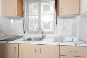 a kitchen with a sink and a window at Villa Repas in Pefkochori +51 photos