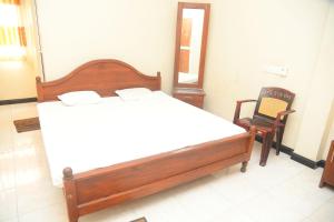 Ένα ή περισσότερα κρεβάτια σε δωμάτιο στο Hotel Prasanna